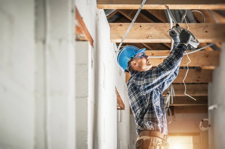 Professional electrician working on electrical wiring installation