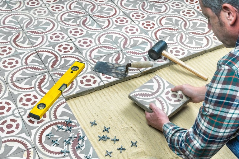 Construction worker installing cement tiles