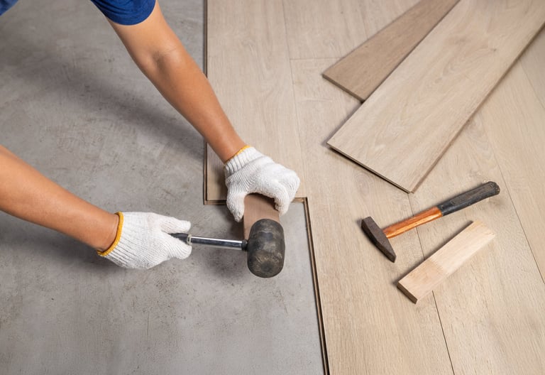 Worker installing laminate floor