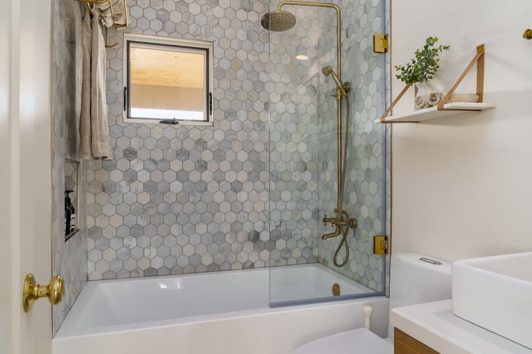 Modern white bathroom with gold fixtures